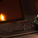 photo of a candle next to a powered-down computer